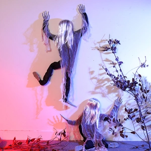 Creepy Halloween climbing ghost wall decor with long silver hair and glowing shadows