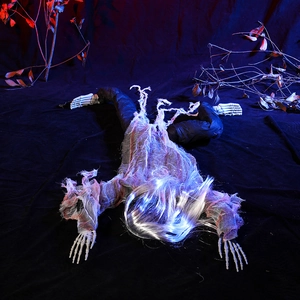 Creepy crawling zombie prop for Halloween with long silver hair and tattered gray robes