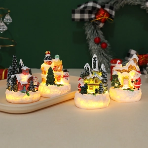 Detail of Christmas village house ornaments with warm LED lights and resin finish