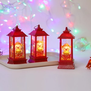 Three red Caishen lanterns with swirling gold glitter and warm LED festive lighting