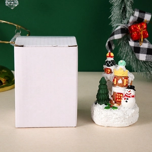 Detailed view of LED Christmas house gift with its white cardboard packaging box