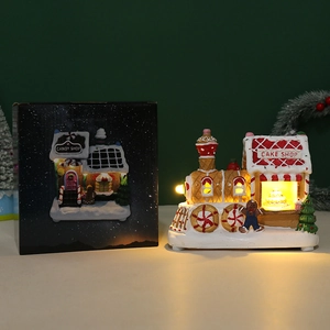 LED gingerbread house train Christmas ornament with festive retail gift box packaging