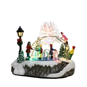 Detailed LED Christmas house resin ornament featuring snowy figures and colored lights