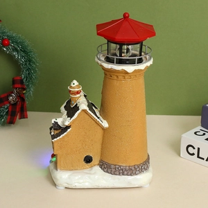 Close-up of LED glowing Christmas lighthouse ornament with resin snow details