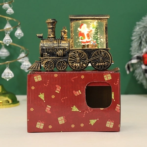 Macro shot of retro Christmas train lantern decoration with Santa Claus and festive packaging