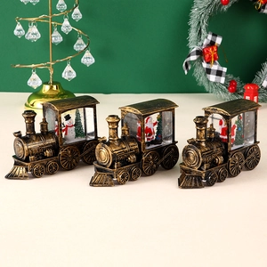 Vintage bronze Christmas train ornaments featuring miniature snowman and Santa scenes