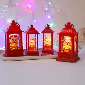 Close-up of decorative red New Year lantern with glowing light and Caishen figurine inside