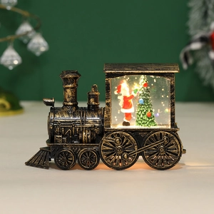 Macro shot of retro gold train lantern with warm LED light and Santa Claus miniature scene