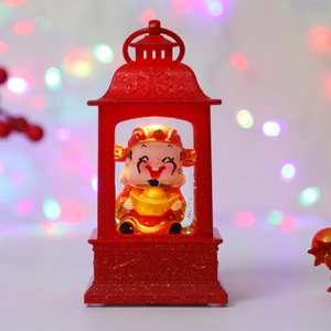 Detail of red festive lantern featuring a cute Caishen figure and golden glitter finish