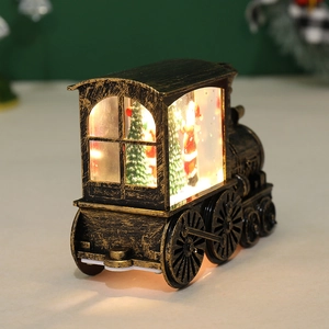 Close-up of vintage bronze Christmas train lantern with warm LED light and miniature scene