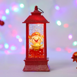 Close-up of God of Wealth lantern with swirling gold glitter and warm LED light effect
