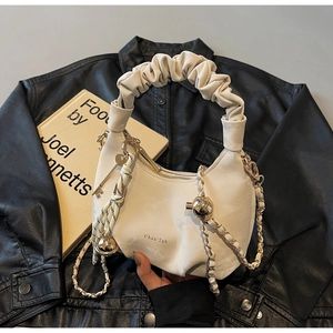 Detail of off-white ruched cloud bag featuring gold chain strap and brand logo