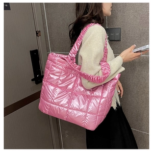 Detail of metallic pink quilted tote bag with unique scrunchie handle and square stitching