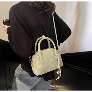 Detail of light green marble texture handbag with double handles and long strap