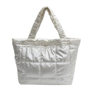 Quilted silver tote bag with padded square pattern and decorative ruched handles