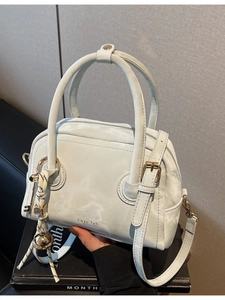 Chic mint green leather Boston bag with double handles and a stylish crossbody strap