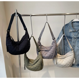 Detailed quilted nylon crescent bags in four colors with braided zipper pullers