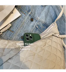 Close-up of the internal zipper pocket and ample storage space in the quilted beige hobo bag