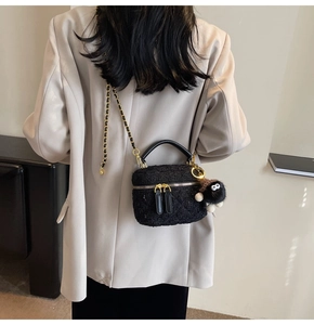 Mini black tweed crossbody bag with gold chain strap and cute soot sprite plush charm