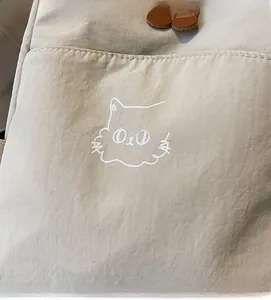 Detail of light beige nylon fabric with fashion cat print and smooth textile texture
