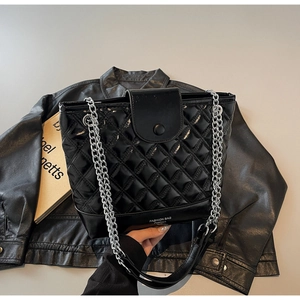 Detail of black quilted patent leather bucket bag with silver chain and Fashion Bag logo