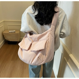 Detailed back view of pink puffer tote bag showing padded texture and side pockets