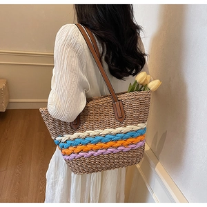 Detailed weave pattern and colorful stripes on the large straw tote bag with leather strap
