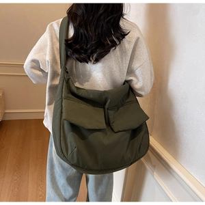 Detailed back view of an olive green large nylon tote bag with two front flap pockets