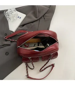 Red quilted leather bag detail showing spacious interior with luxury silver chain strap
