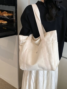 Large capacity off-white canvas tote bag for women with wide straps and external pockets
