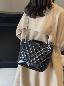 Quilted black bucket bag with silver chain strap and white fashion lettering print
