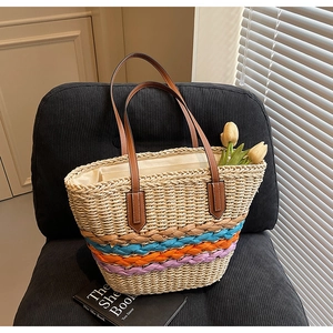 Detailed macro shot of the colorful wave pattern stitching on a straw tote beach bag