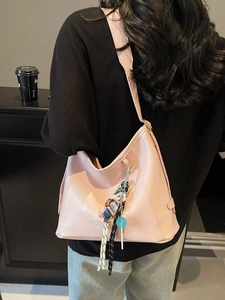 Pink leather hobo shoulder bag with cute charms and embossed logo for women