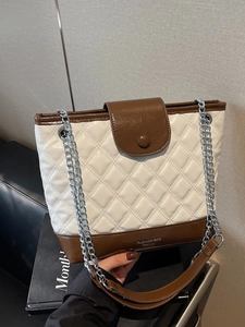 Contrast quilted bucket bag in beige and brown with silver chain strap and top handle