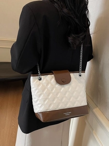 Quilted bucket bag with white patent leather and brown contrast in chain strap style