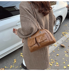 Brown quilted leather chain shoulder bag with double pocket detail on vintage boston style