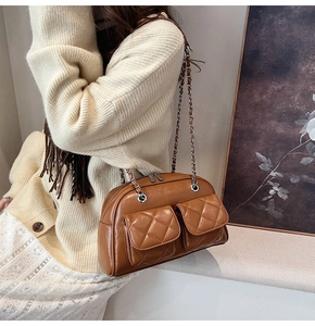 Brown retro quilted pillow bag with chain strap shown on a model for daily styling
