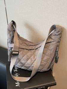 Taupe quilted crescent crossbody bag with diamond stitch nylon and woven strap