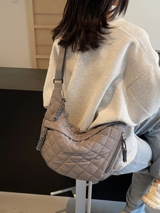 Grey diamond quilted crossbody bag with stylish hobo shape and wide shoulder strap