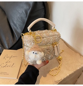 Detail of champagne tweed mini box bag with sequins, gold chain and plush monster charm
