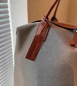 Detailed close-up of premium nylon fabric texture and leather straps on large tote bag