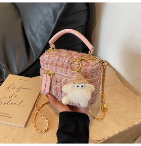 Detailed macro of pink tweed quilted box bag featuring champagne gold metal chain and hardware