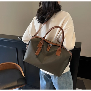 Olive green large nylon tote travel bag with leather handles and detachable shoulder strap