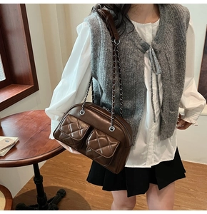 Close-up of vintage brown quilted shoulder bag with chain strap and dual front pockets