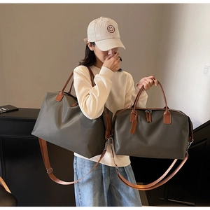 Size comparison of olive green nylon travel duffel bags with premium leather handles