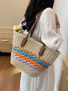 Straw beach tote bag with colorful braided waves and brown leather shoulder straps