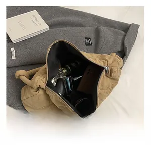 Spacious interior of khaki quilted tote bag showing daily essentials and knot handle