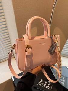 Pink leather square handbag with top handle, crossbody strap and abacus charm detail