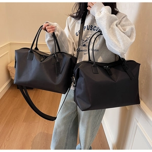 Detail of large nylon tote bag and leather travel bag with adjustable straps