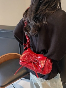 Fashionable red shiny shoulder bag with large bow detail and pleated design for women
